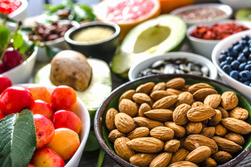 Bowl with almonds and other superfoods on table. Breakfast containing healthy food, organic vegetarian nutrition like nuts and fruits