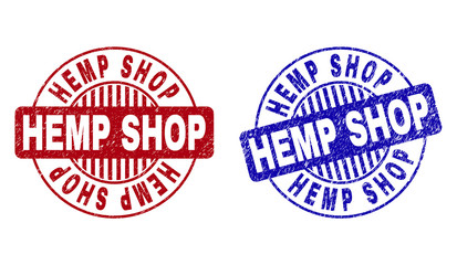 Grunge HEMP SHOP round stamp seals isolated on a white background. Round seals with grunge texture in red and blue colors. Vector rubber overlay of HEMP SHOP tag inside circle form with stripes.