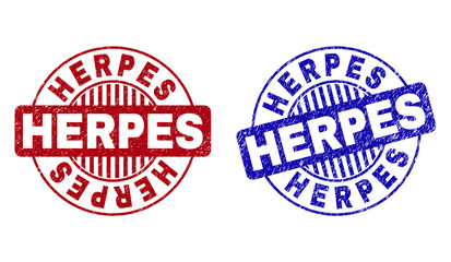 Grunge HERPES round stamp seals isolated on a white background. Round seals with grunge texture in red and blue colors. Vector rubber overlay of HERPES label inside circle form with stripes.
