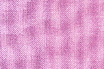 Abstract blank background for layouts. Thick pink fabric close up. Light photo.