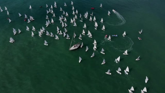 Aerial view many sailboats in sea during regatta. Fly over sailing boat with white sails.