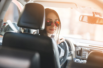 Naklejka premium woman posing in the car. female driving car. attractive young lady in the automobile. woman outdoors.