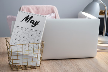 Flip calendar and laptop on table