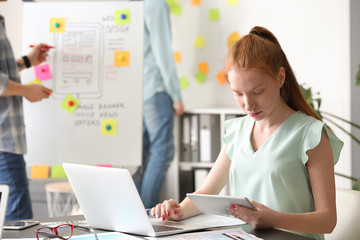 Female IT designer working in office