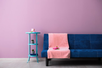 Interior of modern room with comfortable sofa and table