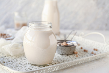 Jar of healthy soy milk on table