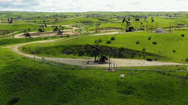 Wunpost CA aerial drone video of oil fields pumping action