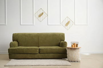 Comfortable sofa with table in interior of room