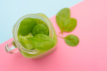 smoothie of spinach on a colored background
