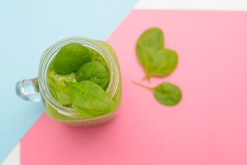 smoothie of spinach on a colored background