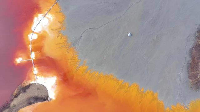  Flying over chemical waste, water polluted with contaminated mining residuals from a copper mine, abandoned church buried under toxic cyanide liquids mixing into lake. 4k Aerial drone view,  ecologic