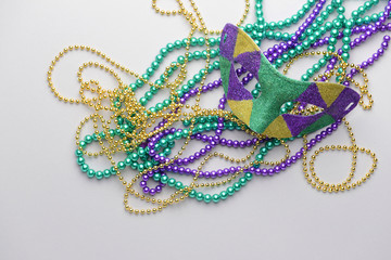 Festive mask with beads on light background