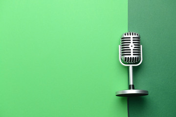 Retro microphone on color background