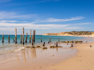 Old wooden pier posts at Port Willunga beach, Adelaid, South Australia