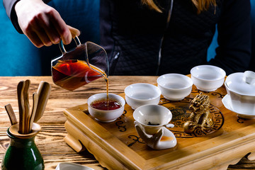 tea ceremony, the girl pours tea puer in bowls