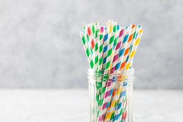 Colorful paper straws for cocktail in a glass.