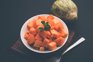 Cantaloupe / muskmelon / kharbuja cut into pieces, served in a bowl. selective focus