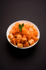 Cantaloupe / muskmelon / kharbuja cut into pieces, served in a bowl. selective focus