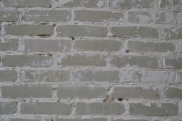 Light white or grey brick wall of antique church. Texture wallpaper background. Dirty old wall. Vintage structure.