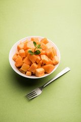Cantaloupe / muskmelon / kharbuja cut into pieces, served in a bowl. selective focus