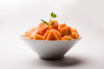 Cantaloupe / muskmelon / kharbuja cut into pieces, served in a bowl. selective focus