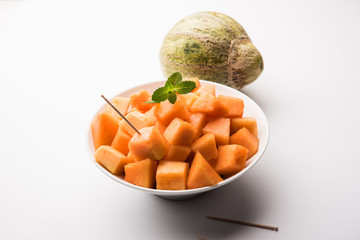 Cantaloupe / muskmelon / kharbuja cut into pieces, served in a bowl. selective focus
