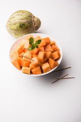 Cantaloupe / muskmelon / kharbuja cut into pieces, served in a bowl. selective focus
