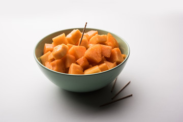 Cantaloupe / muskmelon / kharbuja cut into pieces, served in a bowl. selective focus