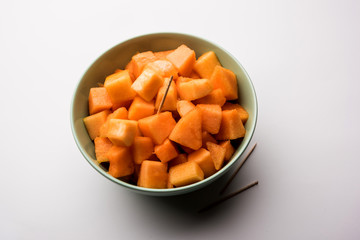 Cantaloupe / muskmelon / kharbuja cut into pieces, served in a bowl. selective focus