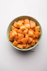 Cantaloupe / muskmelon / kharbuja cut into pieces, served in a bowl. selective focus