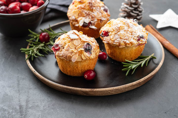 Muffins, cakes with cranberry, rosemary and almond nuts. Christmas decoration. Copy space.