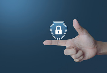 Hand pressing padlock with shield flat icon over light gradient blue tone background, Business security insurance concept