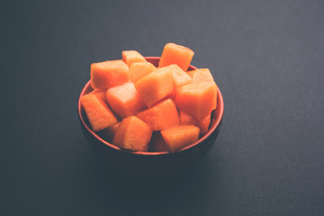 Cantaloupe / muskmelon / kharbuja cut into pieces, served in a bowl. selective focus