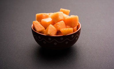 Cantaloupe / muskmelon / kharbuja cut into pieces, served in a bowl. selective focus