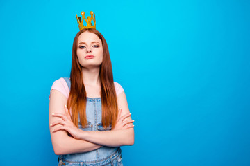 Close up photo beautiful amazing she her lady headwear head glossy yellow gold crown showing presenting special status wear casual jeans denim overalls clothes isolated blue bright background © deagreez