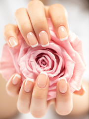 Woman gets manicure procedure in a spa salon. Beautiful female hands. - obrazy, fototapety, plakaty