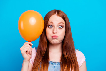 Close up photo beautiful amazing she her lady carefree weekend playful cheerful childish mood play air balloon toothy smiling wear casual jeans denim overalls clothes isolated blue background