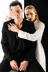 Blonde-haired model hugging her colleague and closing his eye