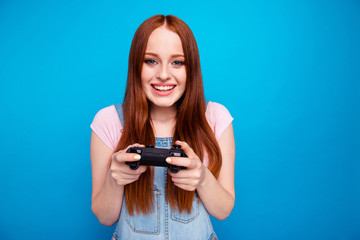 Close up photo beautiful amazing she her lady funny hold hands arms video game controller hard match worry team success want win wear casual jeans denim overalls clothes isolated blue background