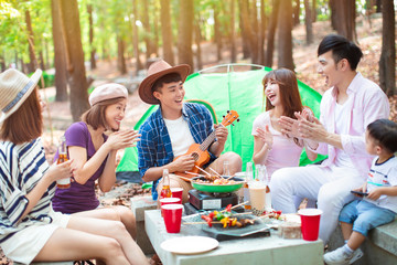 happy asian young group enjoying picnic party and camping