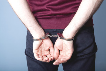 handcuffed man angle from behind