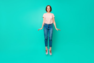 Full length body size photo beautiful her she lady jumping high pretty appearance sweet cute toothy short straight hairdo wear casual jeans denim pastel t-shirt isolated teal turquoise background