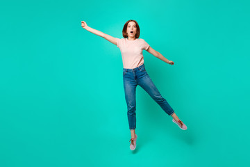 Full length body size photo beautiful amazing her she lady jumping high yell unexpected unbelievable flight merry umbrella wear casual jeans denim pastel t-shirt isolated teal turquoise background