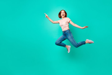 Fototapeta na wymiar Full length body size photo beautiful amazing her she lady flight jump high indicate empty space new low little prices wear casual jeans denim pastel t-shirt isolated teal turquoise background