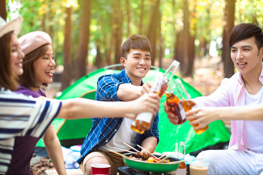 young Friends hands toasting beer and having fun cheering - Powered by Adobe
