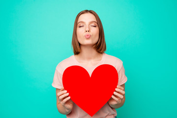 Close up photo beautiful funny funky her she lady send air kisses hands arms hold pretty sweet large heart shape figure postcard wear casual pastel t-shirt clothes isolated teal turquoise background