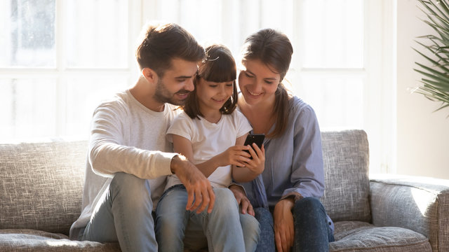 Little girl showing to parents favourite game play online
