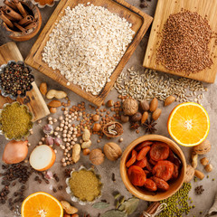 Dried fruits cereals spices and nuts organic healthy snacks on a textural background. The concept of healthy eating. Lean foods.