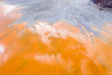 Aerial view of a mining decanting pond with toxic red residuals