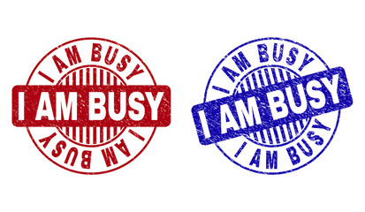 Grunge I AM BUSY round stamp seals isolated on a white background. Round seals with distress texture in red and blue colors. Vector rubber watermark of I AM BUSY tag inside circle form with stripes.